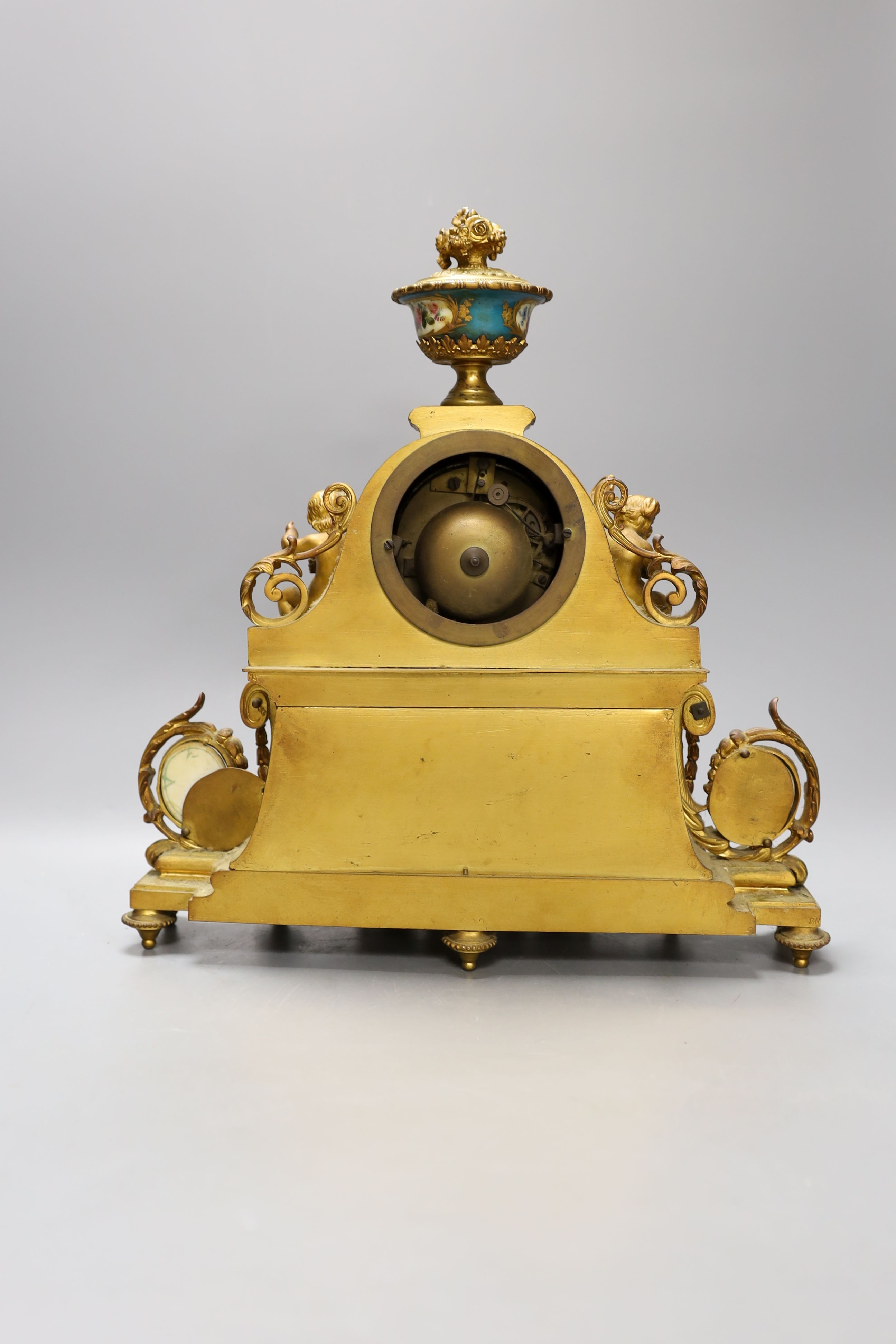 A 19th century French ormolu and Sevres style porcelain mounted mantel clock, with key and pendulum, 35 cm high